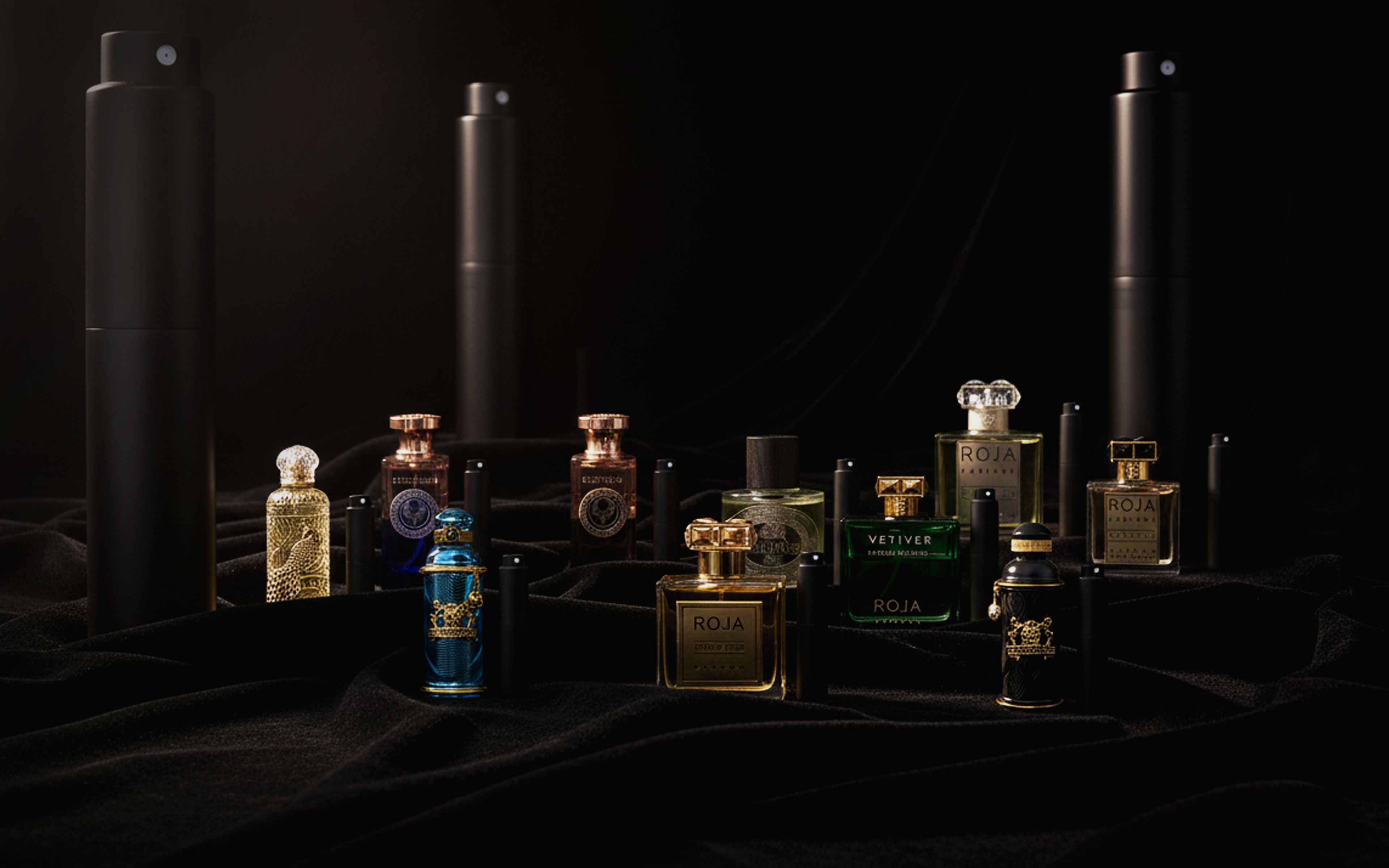 Luxury perfumes displayed among black perfume bottles