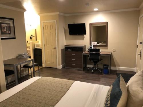 Photo of El Castell Motel - Room, King Bed, Flat TV, Table & 2 Chairs, Work Desk, Fridge, Microwave, Coffee Machine