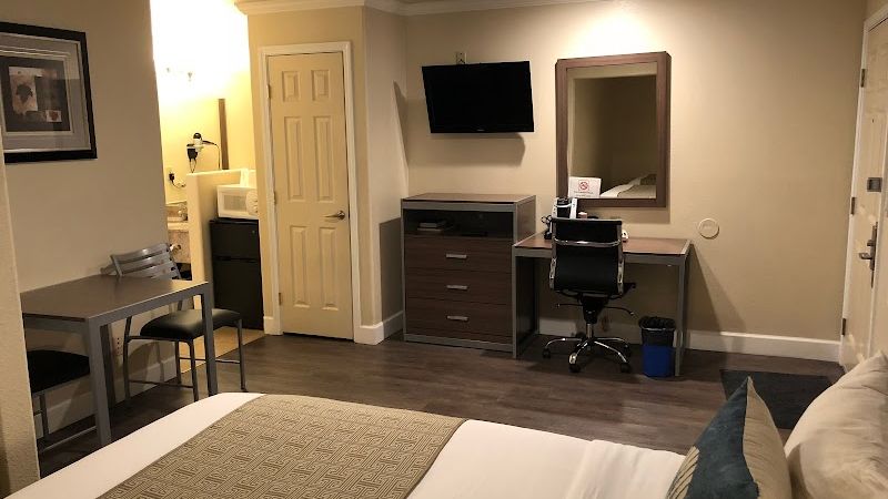 Photo of El Castell Motel - Room, King Bed, Flat TV, Table & 2 Chairs, Work Desk, Fridge, Microwave, Coffee Machine