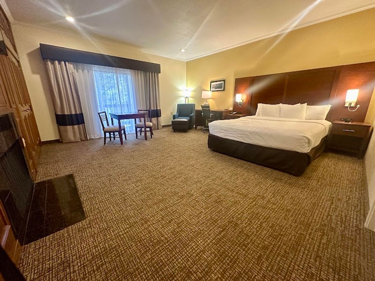 Photo of Comfort Inn Monterey Peninsula Airport - Suite, King Bed, Fireplace, Table & Chairs