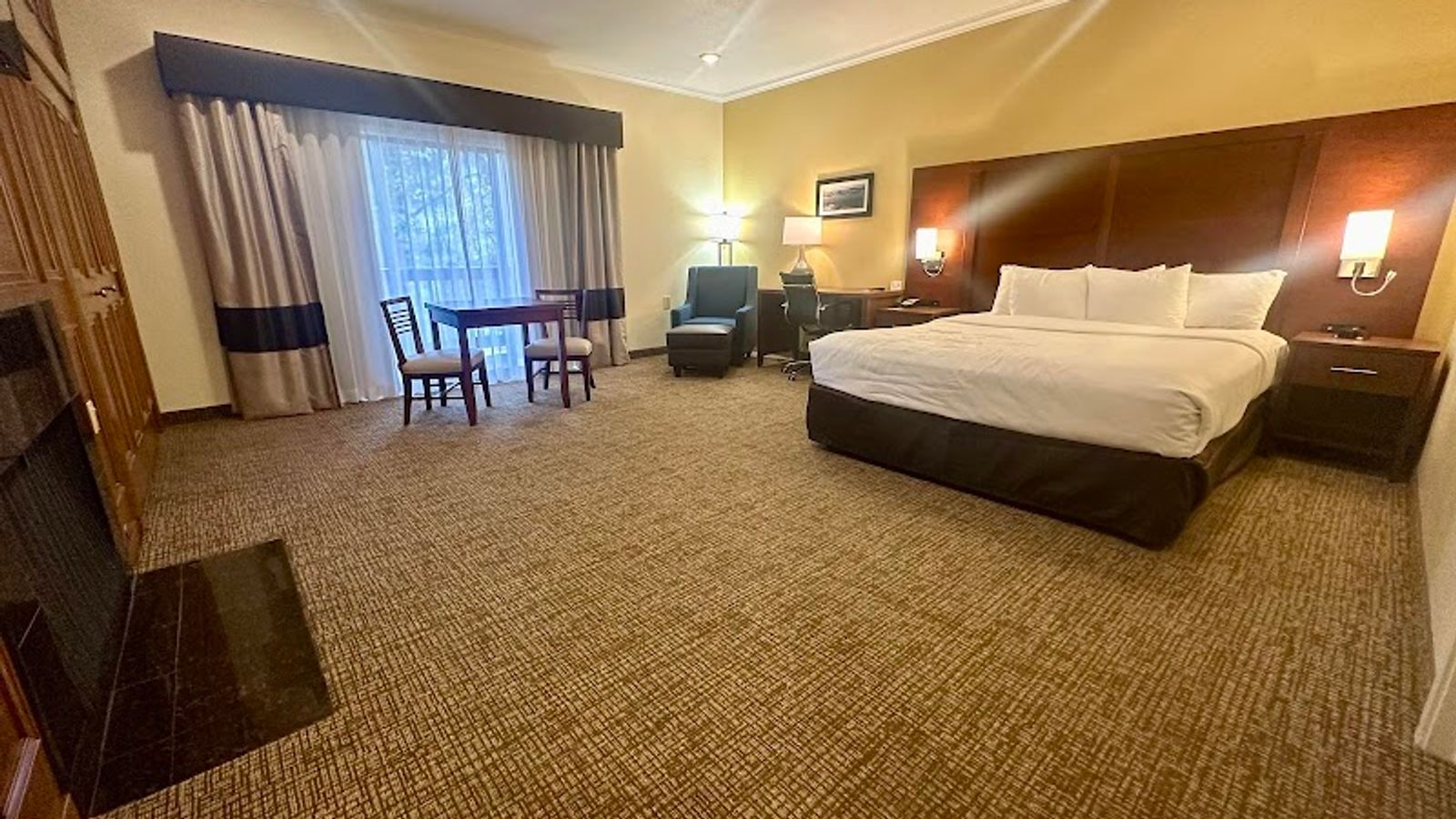 Photo of Comfort Inn Monterey Peninsula Airport - Suite, King Bed, Fireplace, Table & Chairs