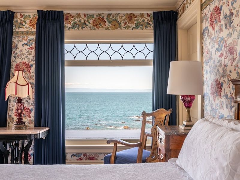 Photo of Martine Inn - Marie’s Room with king-size bed, ocean views, and a romantic claw-foot tub