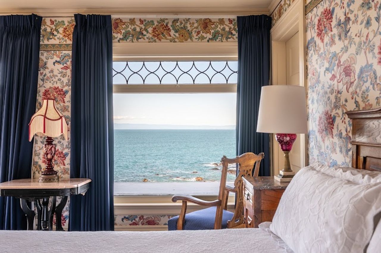 Photo of Martine Inn - Marie’s Room with king-size bed, ocean views, and a romantic claw-foot tub