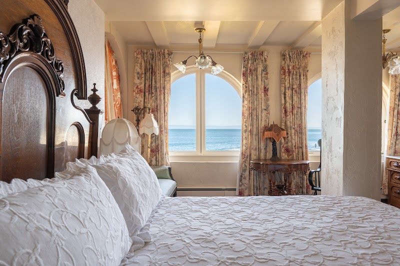 Photo of Martine Inn - Victoriana Room with king bed and arched bay windows with wonderful views of the coastline