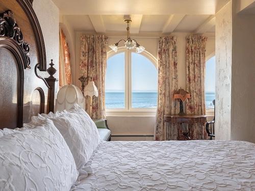 Photo of Martine Inn - Victoriana Room with king bed and arched bay windows with wonderful views of the coastline