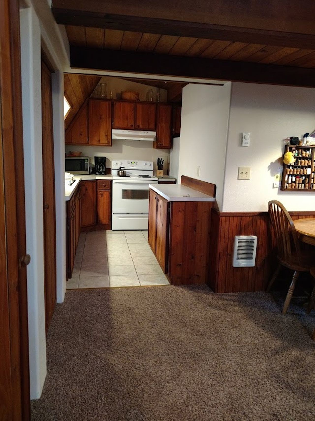 Photo of Almost Paradise Lodging at Mt. Rainier - Woodland Cabin, Kitchen — well equipped with microwave, refrigerator, range, coffee maker/grinder, toaster, dishes, utensils, pots, coffee beans, tea
