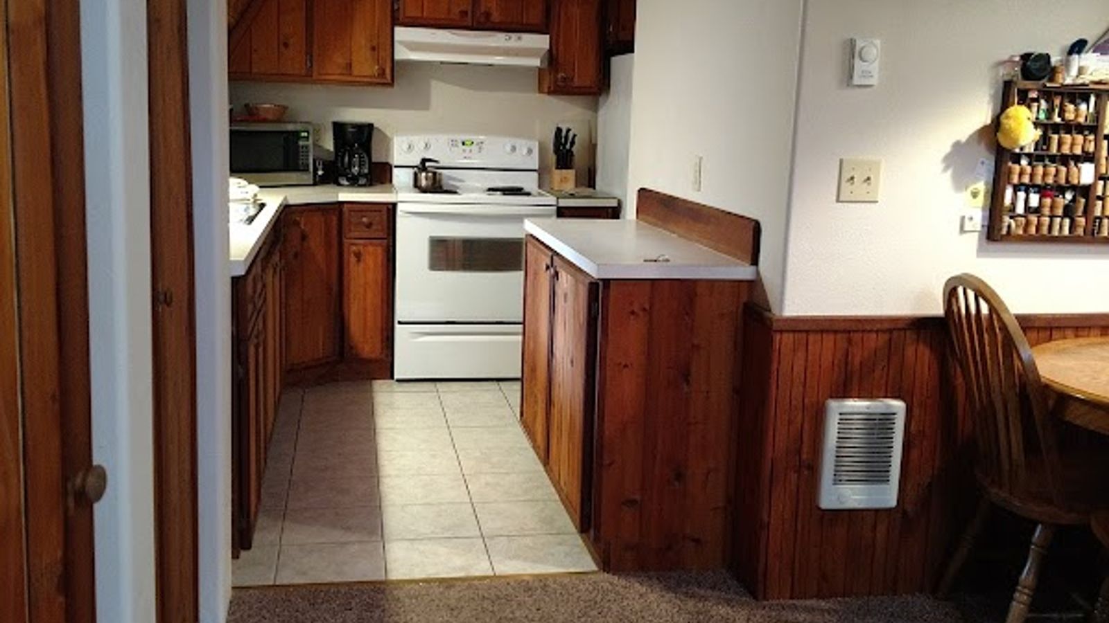 Photo of Almost Paradise Lodging at Mt. Rainier - Woodland Cabin, Kitchen — well equipped with microwave, refrigerator, range, coffee maker/grinder, toaster, dishes, utensils, pots, coffee beans, tea