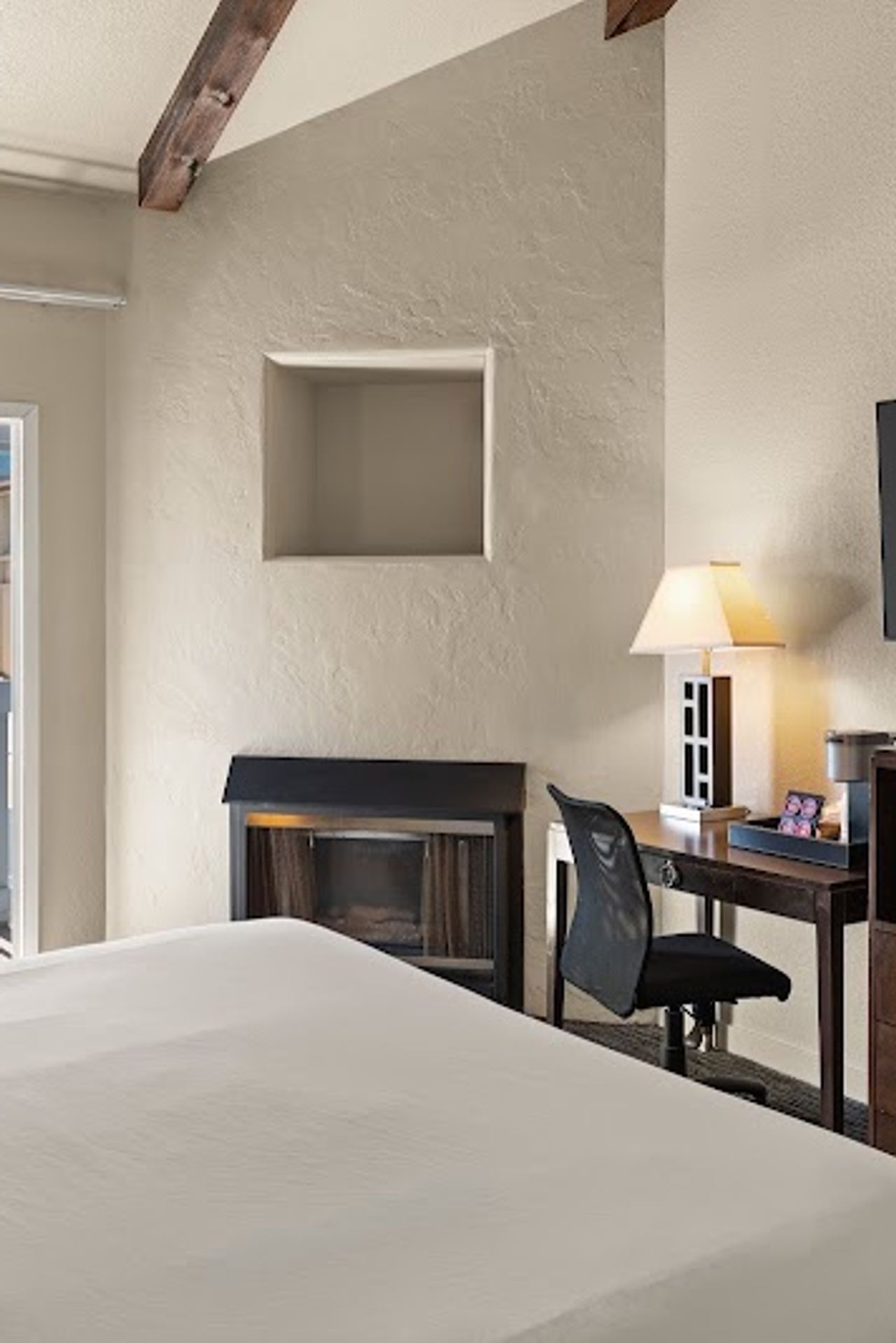 Photo of Cannery Row Inn - 1 King Room, a fireplace, microwave and refrigerator, coffee maker, and bathroom