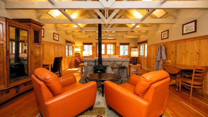 Photo of Sleeping Lady Mountain Resort & Spa - Eyrie Cabin, living room area with a wood stove with leather seating