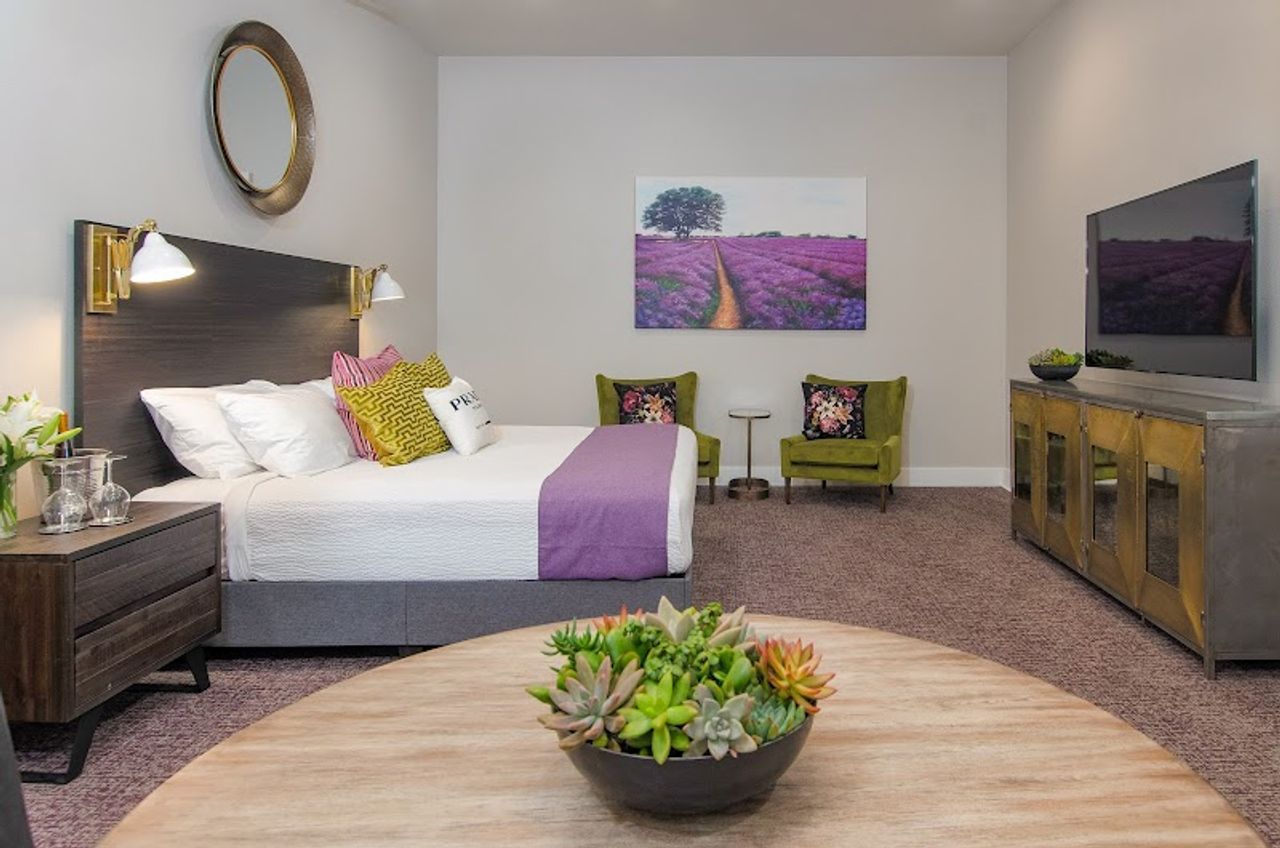 Photo of The Dundee Hotel - Suite, Luxury shower, Table and chairs, Full size refrigerator, Kitchenette with sink, cabinets, and large counter space