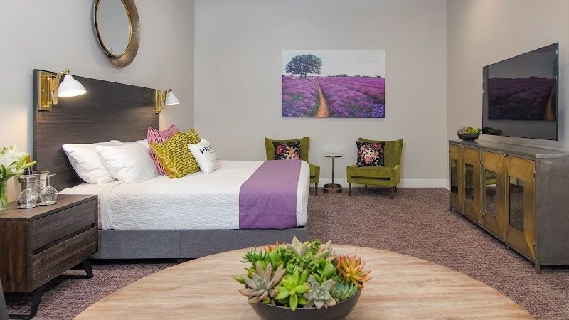 Photo of The Dundee Hotel - Suite, Luxury shower, Table and chairs, Full size refrigerator, Kitchenette with sink, cabinets, and large counter space