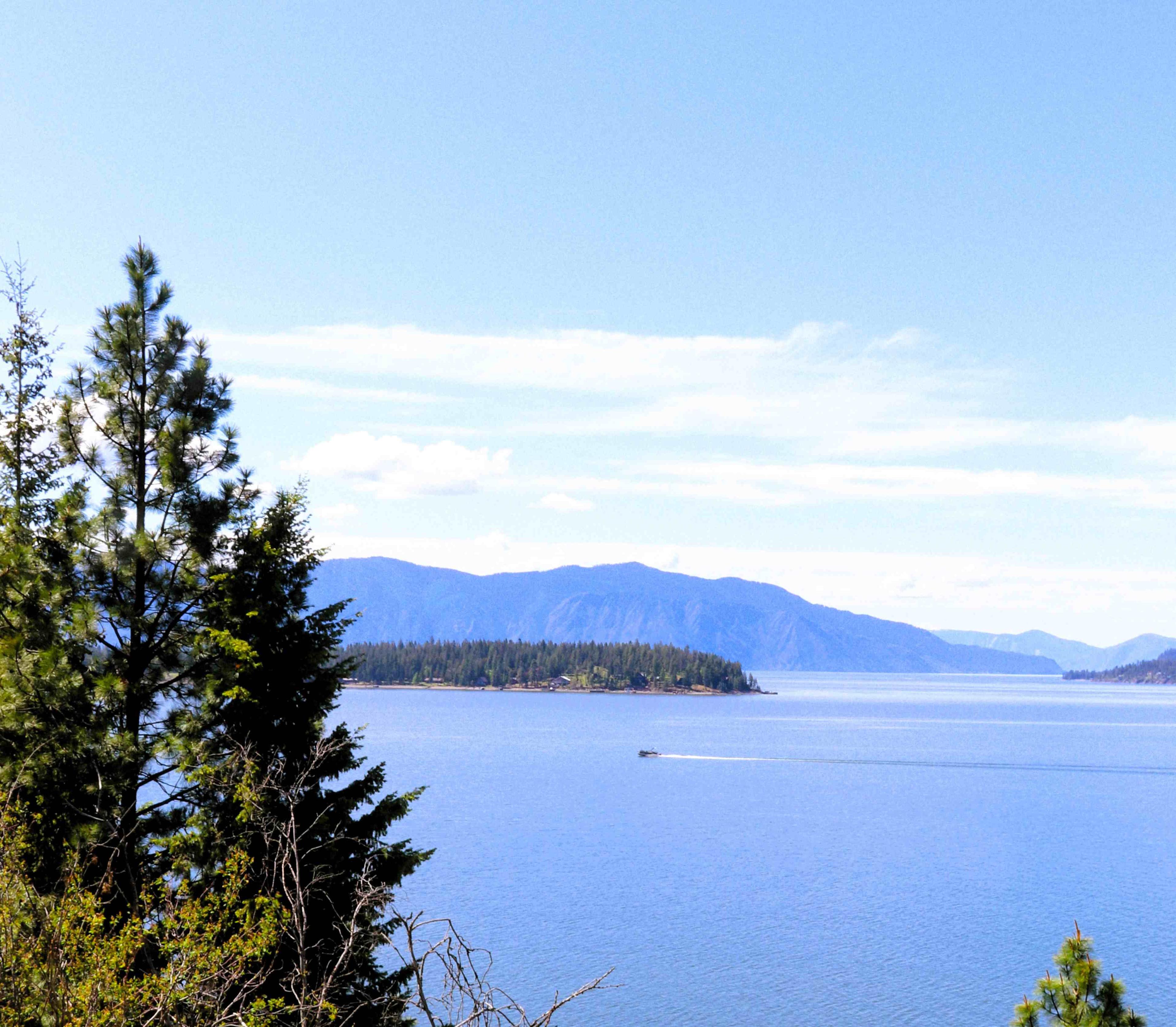 A small boat speeding by on Lake Pend Oreille, Idaho, USA