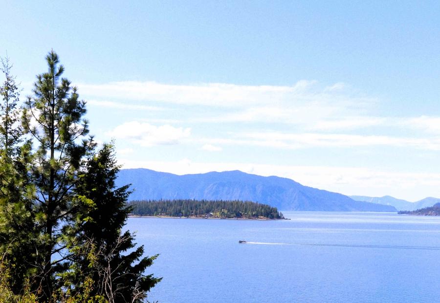 A small boat speeding by on Lake Pend Oreille, Idaho, USA