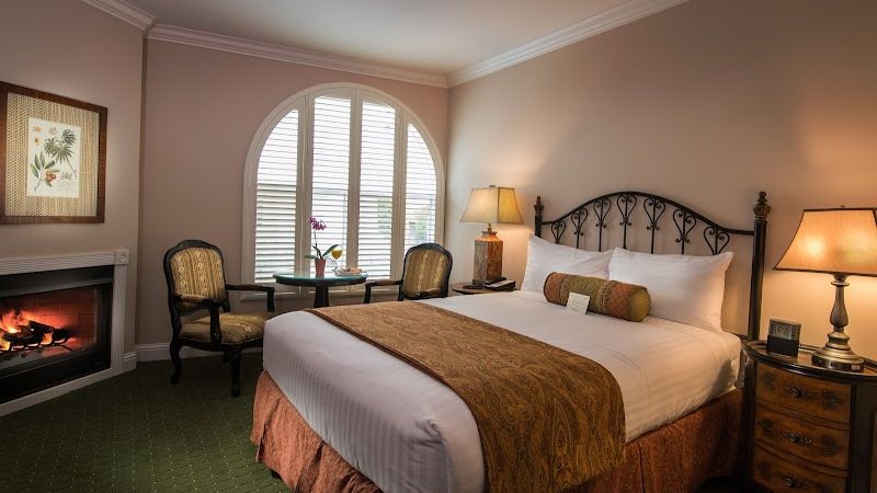 Photo of The Monterey Hotel - Deluxe Queen Room, Fireplace, Chairs and Table