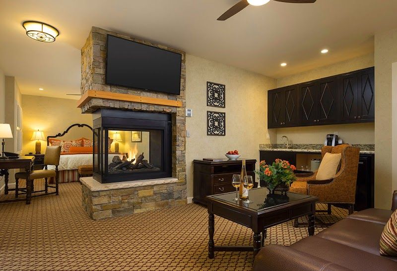 Photo of Casa Munras Garden Hotel & Spa - Junior Suite With Sofa Bed, Fireplace, Separate Living area, 2 55" Flat TVs, large bathroom with a walk-in shower, separate tub, and double vanity