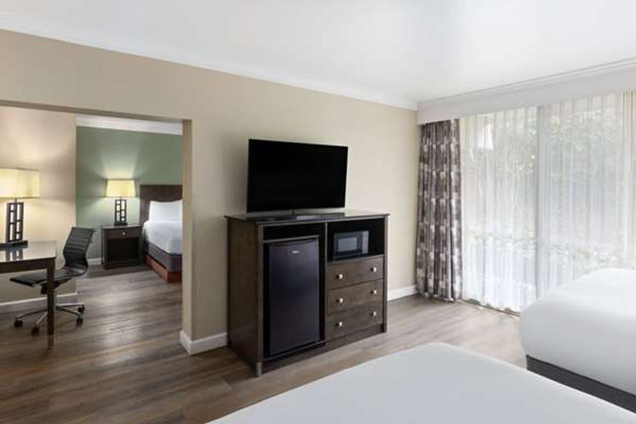 Photo of Travelodge by Wyndham Monterey Bay - Suite, 3 Queen Beds, Flat TV, Fridge, Microwave, Private balcony, Large windows