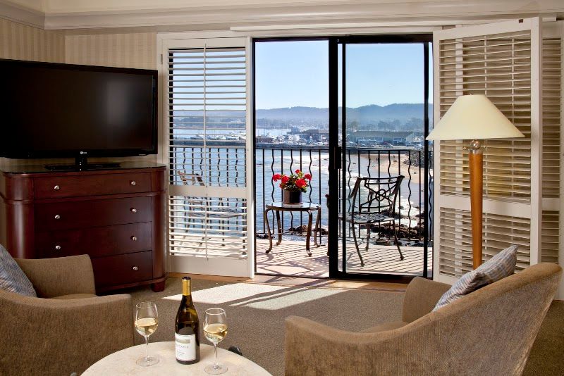 Photo of Monterey Bay Inn - Ocean Harbor View Room, private balcony and one king bed with luxury euro-top bedding