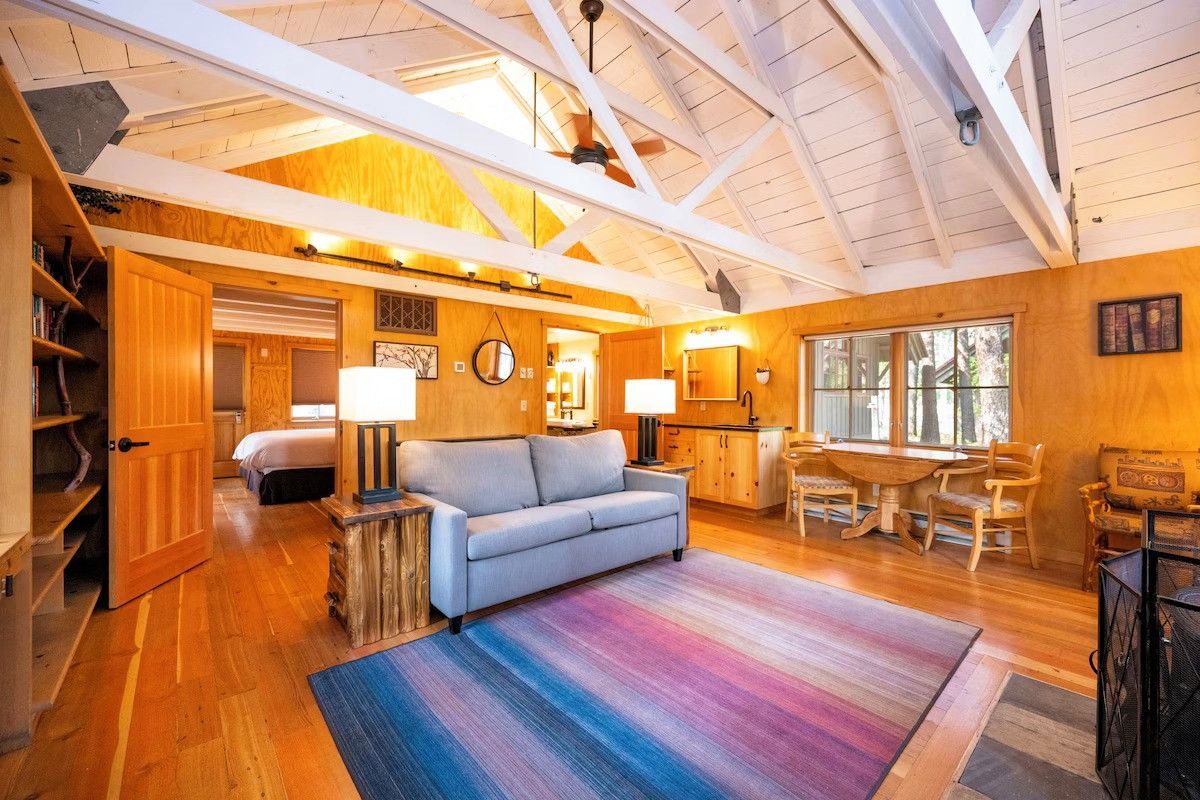 Photo of Sleeping Lady Mountain Resort & Spa - Library Cabin – Living room with a wood-burning stove