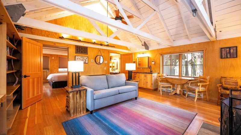 Photo of Sleeping Lady Mountain Resort & Spa - Library Cabin – Living room with a wood-burning stove