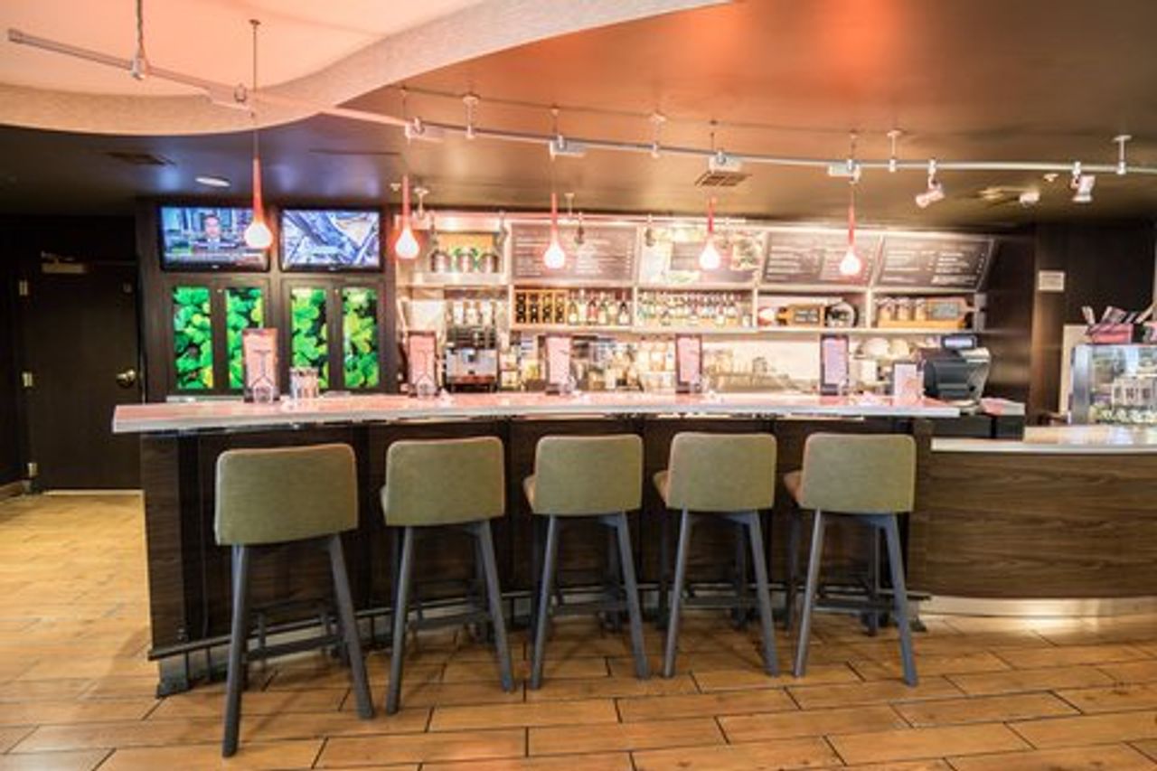 Photo of Courtyard Merced - bar with comfortable seating and a large screen above