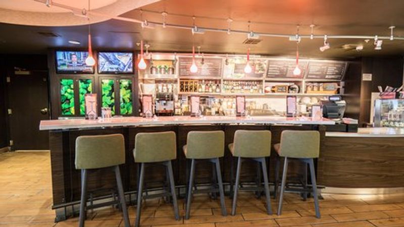 Photo of Courtyard Merced - bar with comfortable seating and a large screen above
