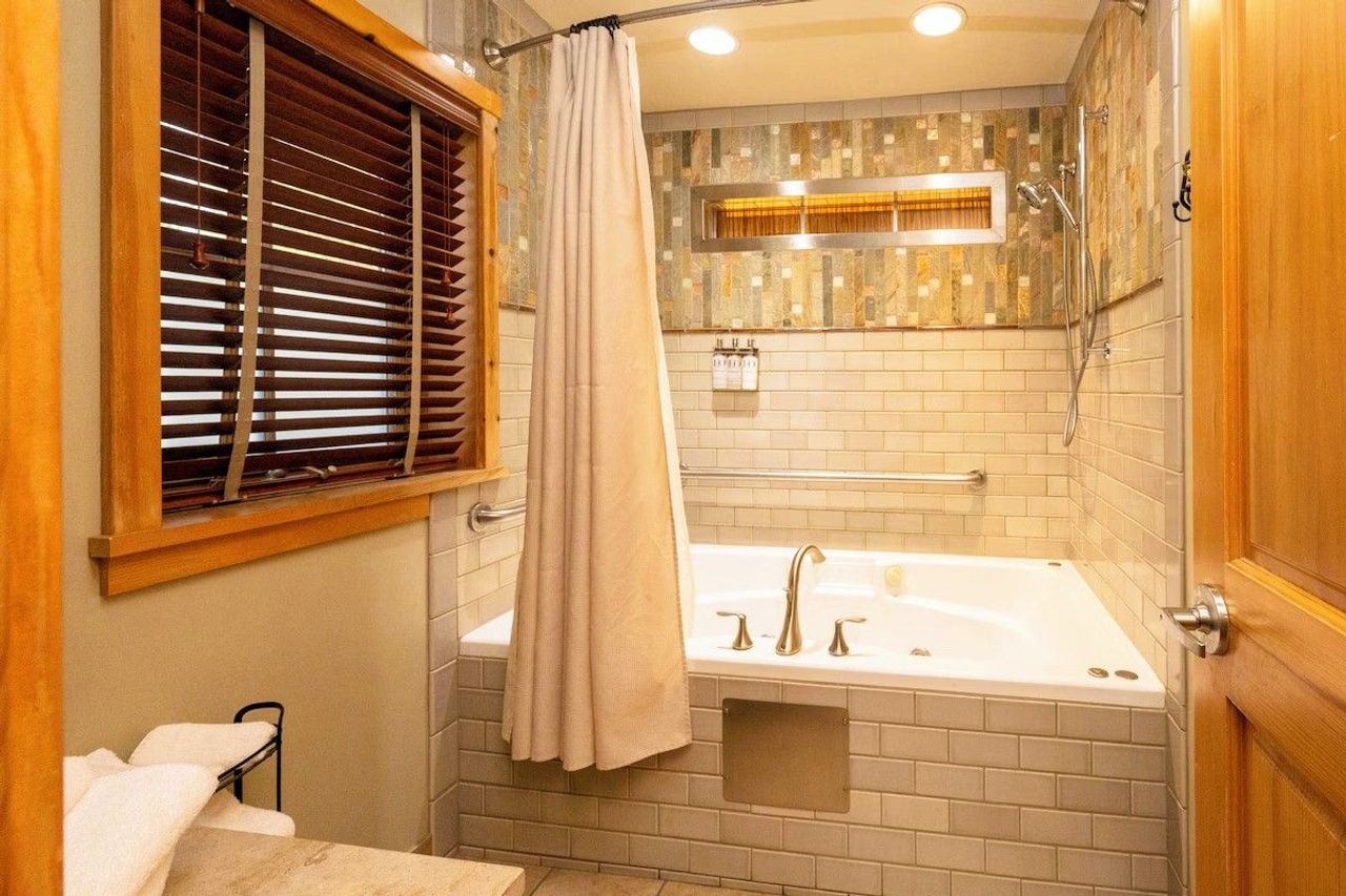 Photo of Sleeping Lady Mountain Resort & Spa - Eyrie Cabin, whirlpool bath surrounded by hand-painted tiles