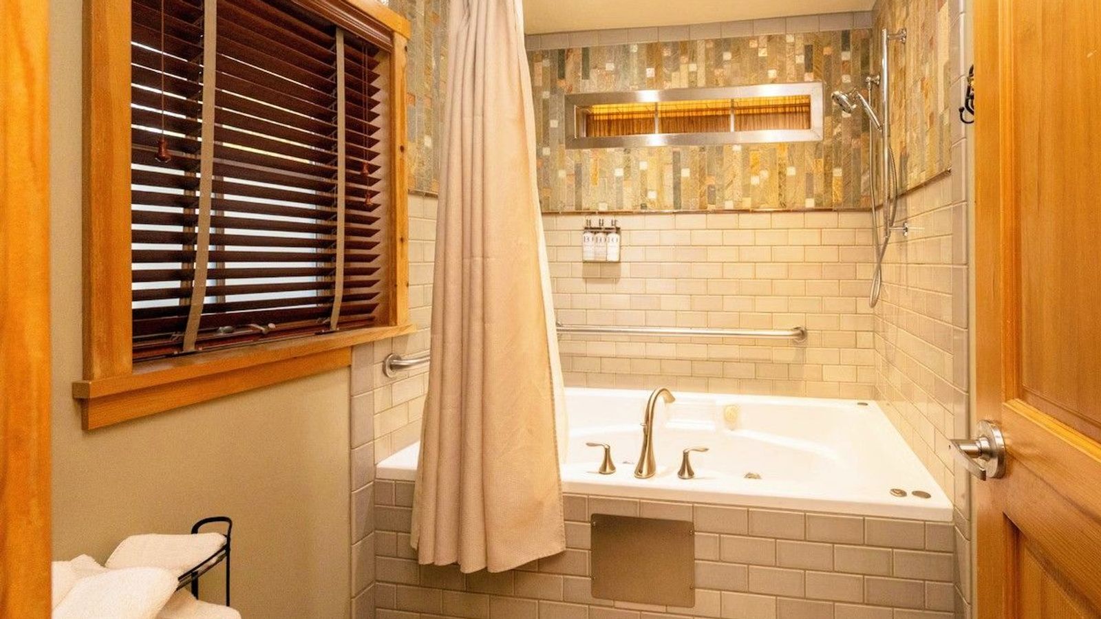 Photo of Sleeping Lady Mountain Resort & Spa - Eyrie Cabin, whirlpool bath surrounded by hand-painted tiles