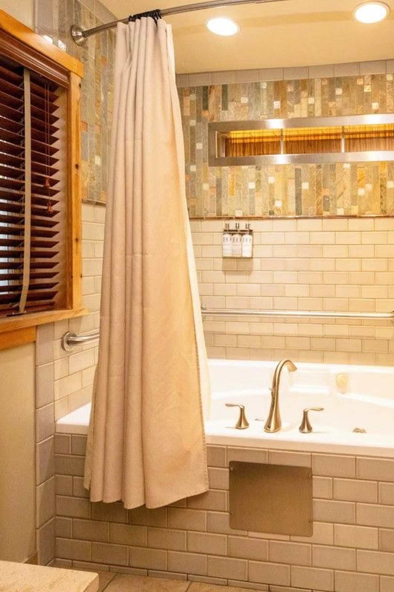 Photo of Sleeping Lady Mountain Resort & Spa - Eyrie Cabin, whirlpool bath surrounded by hand-painted tiles