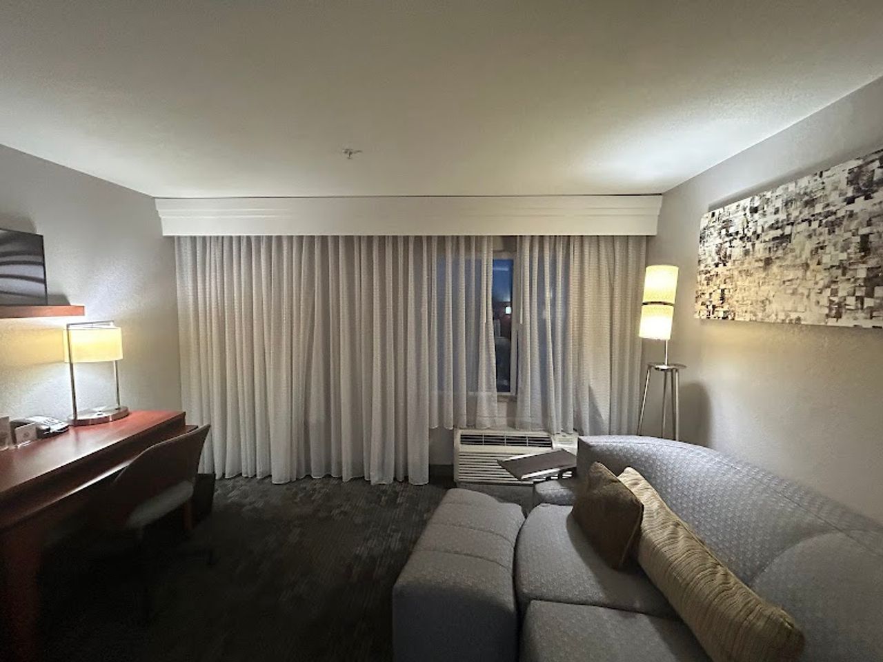 Photo of Courtyard Merced - Suite with comfortable sofa set, armchair, and desk for work or dining