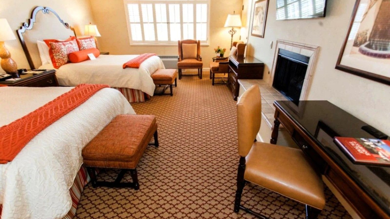 Photo of Casa Munras Garden Hotel & Spa - Deluxe Queen Queen With Fireplace, two queen beds, granite bathroom, USB ports, Keurig coffee maker, and a work desk, flat TV