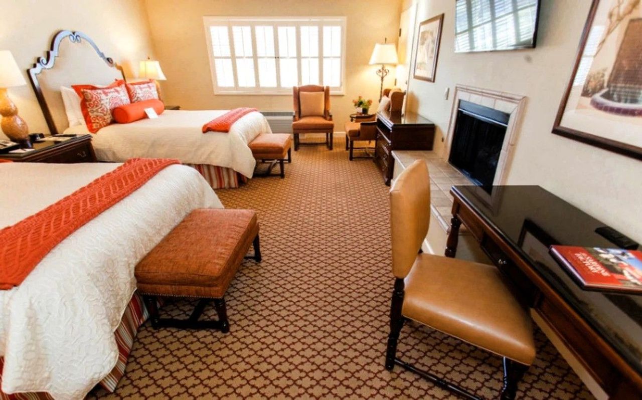 Photo of Casa Munras Garden Hotel & Spa - Deluxe Queen Queen With Fireplace, two queen beds, granite bathroom, USB ports, Keurig coffee maker, and a work desk, flat TV