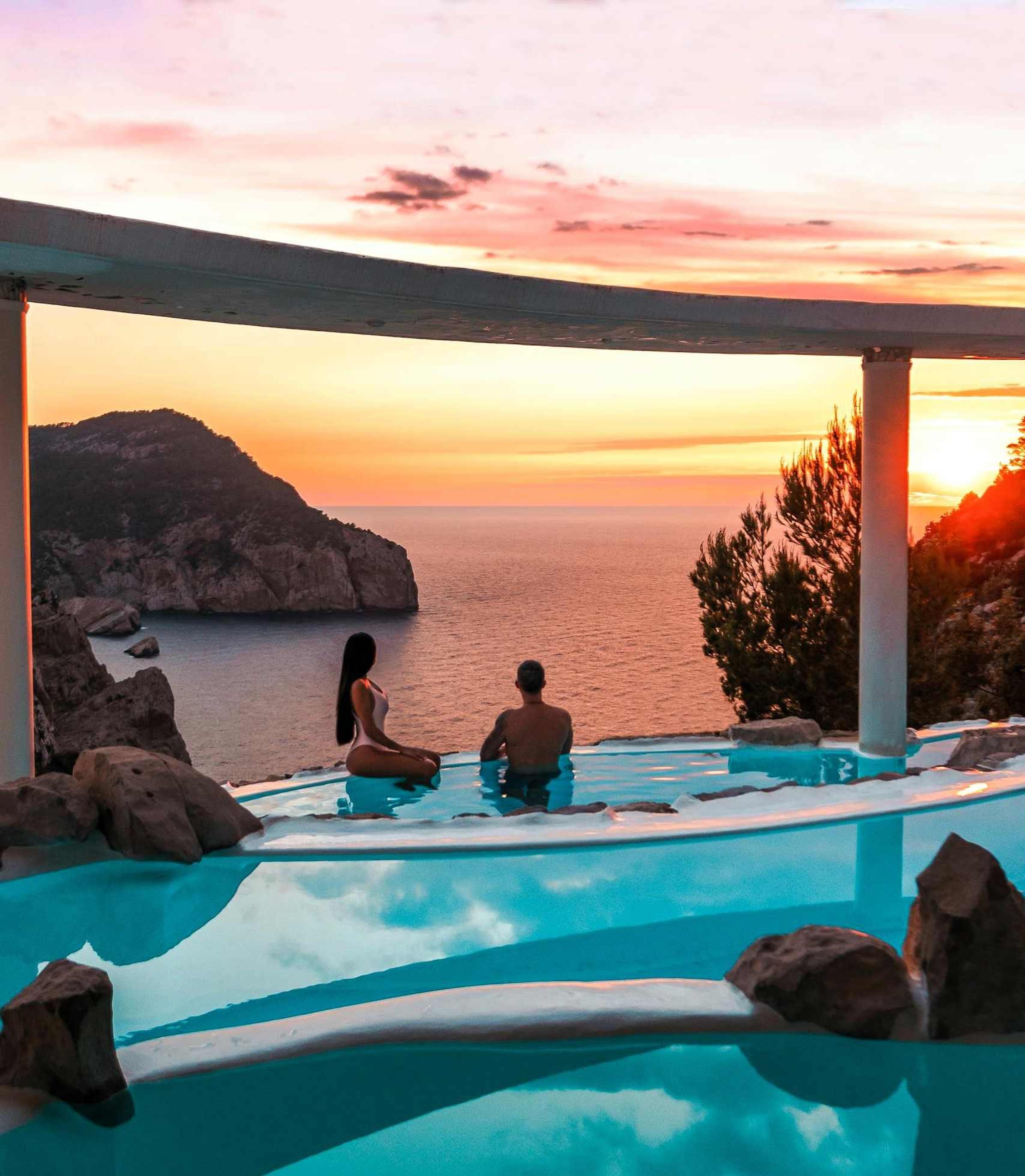 Couple in a pool watching the sunset