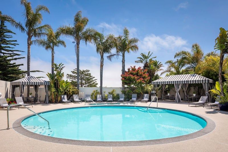 Photo of Portola Hotel & Spa at Monterey Bay - Outdoor pool and Jacuzzi area, loungers and cabana‑style seating