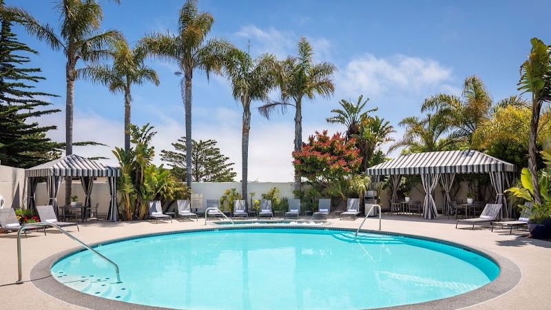 Photo of Portola Hotel & Spa at Monterey Bay - Outdoor pool and Jacuzzi area, loungers and cabana‑style seating