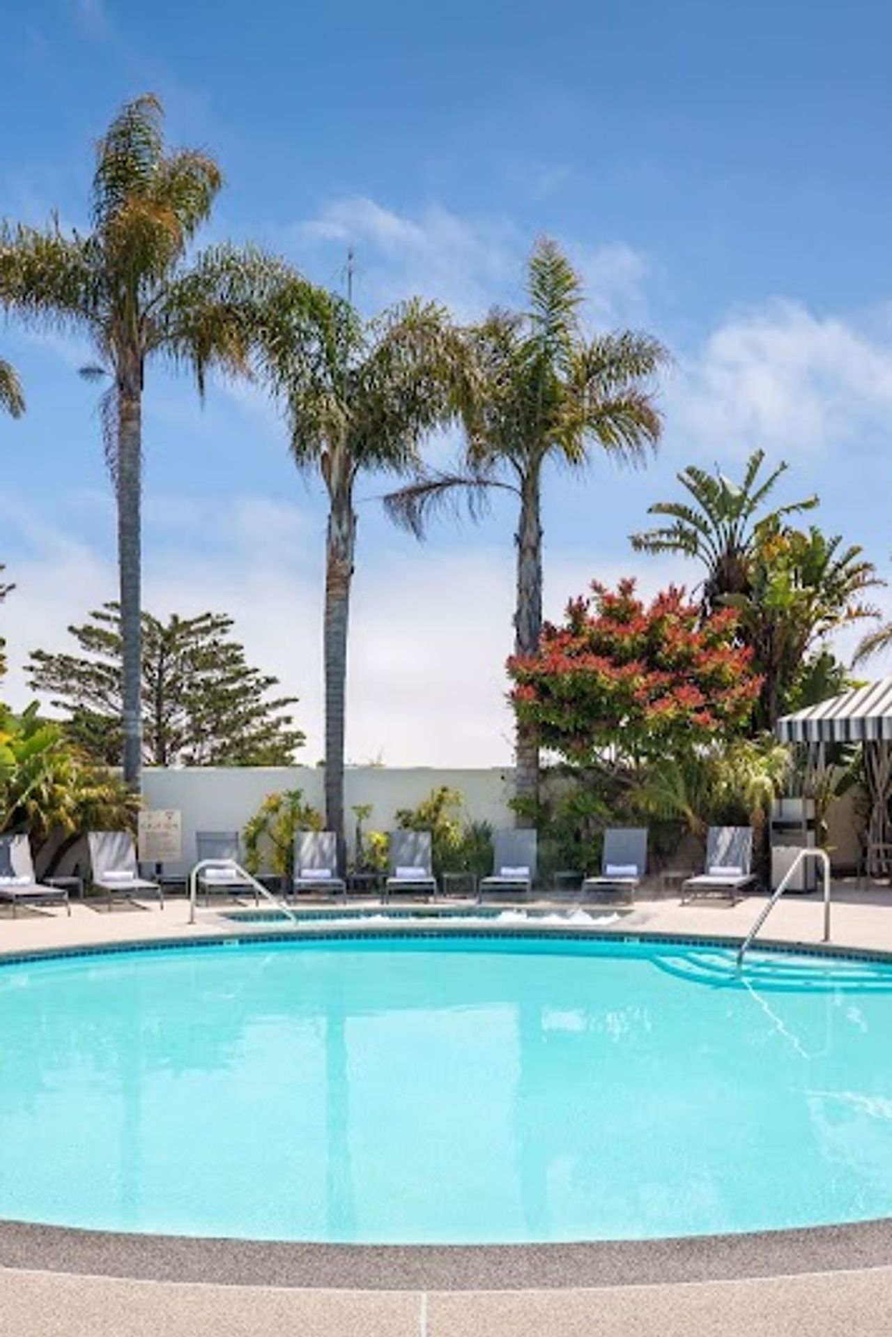 Photo of Portola Hotel & Spa at Monterey Bay - Outdoor pool and Jacuzzi area, loungers and cabana‑style seating