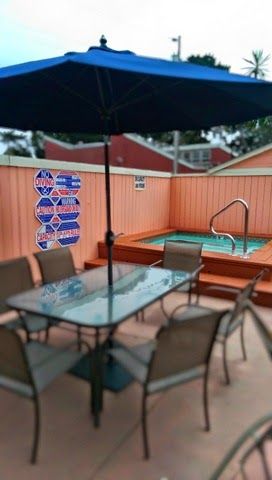Photo of Butterfly Grove Inn - Outdoor seating area and hot tub