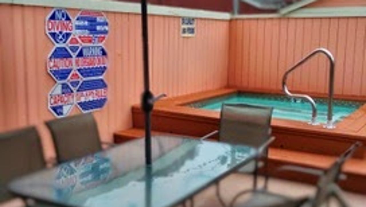 Photo of Butterfly Grove Inn - Outdoor seating area and hot tub
