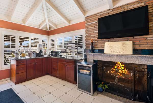 Photo of Clarion Collection Wilkie's Inn Pacific Grove - Monterey - Lobby, fireplace, coffee, tea, flatscreen TV