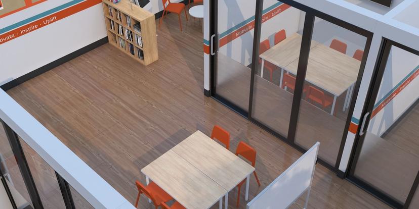an aerial view of a classroom with tables and chairs .