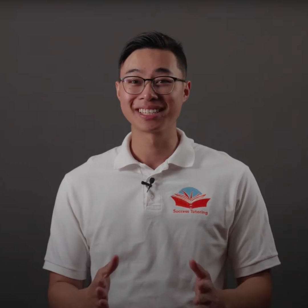a man wearing a white shirt that says success tutoring