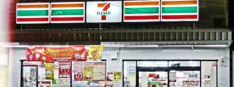A 7-Eleven store in Thailand with scooter standing outside.