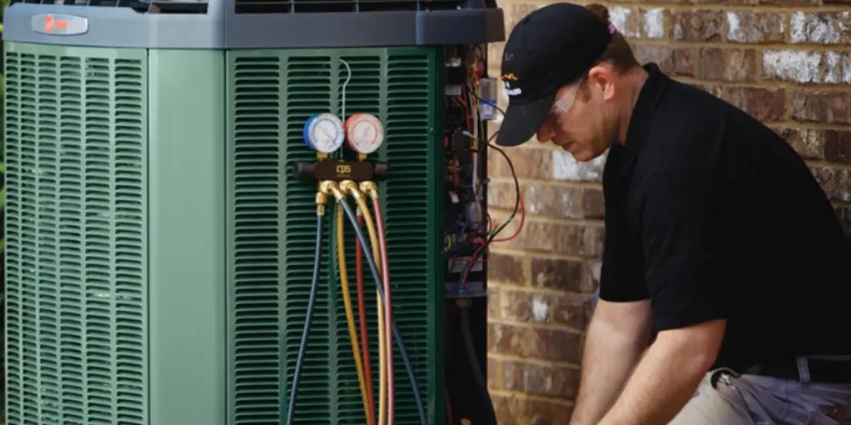 SS&B Heating & Cooling repairman works on air conditioner Springfield MO
