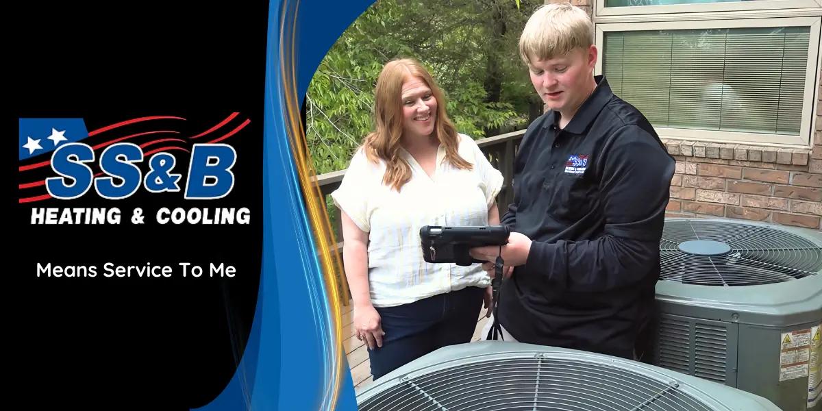 SS&B Heating & Cooling technician consulting with a homeowner in Springfield, MO, discussing HVAC service options and solutions at their residence.