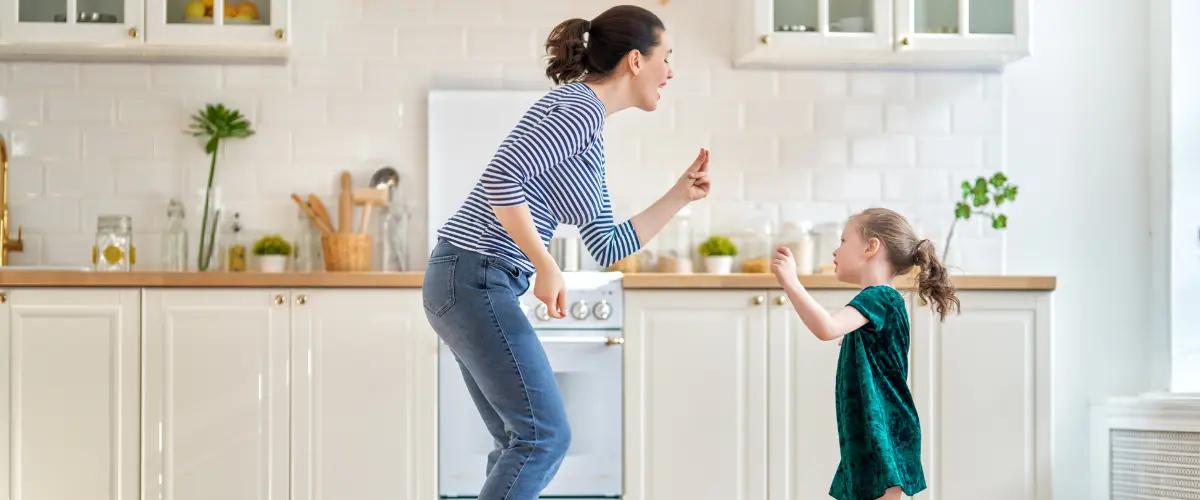 Mother and daughter enjoying a clean, healthy kitchen environment, illustrating the effectiveness of air scrubbers in removing contaminants and ensuring safe indoor air quality for the whole family.