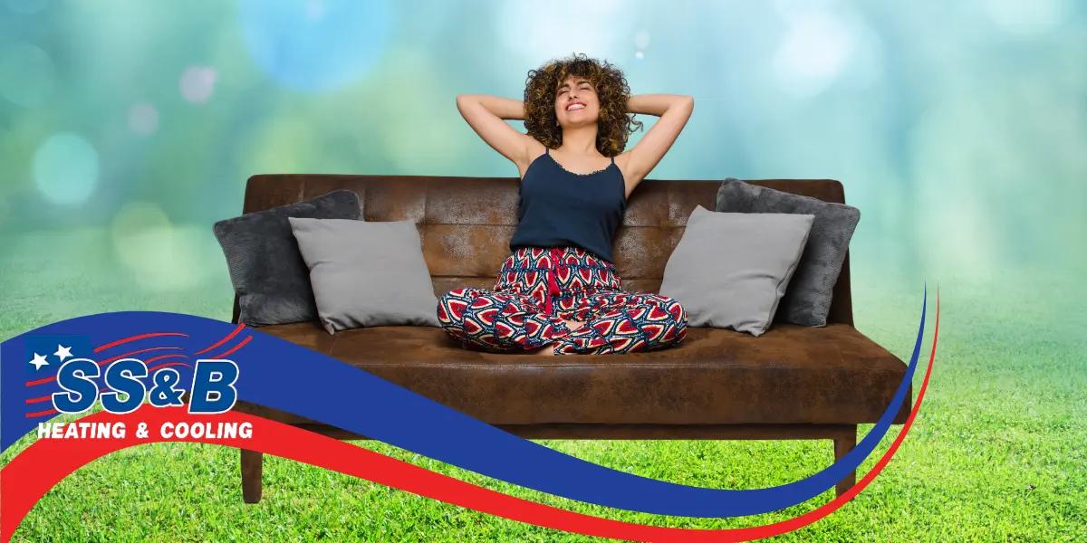 Woman relaxing at home, enjoying the quiet comfort provided by a low-noise HVAC system, free from loud sounds.