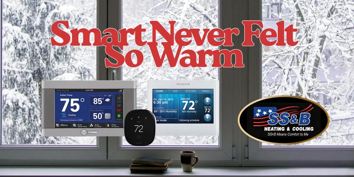 Smart thermostats from Trane, Honeywell, and ecobee displayed in front of a snowy window with text reading ‘Smart Never Felt So Warm.’ SS&B Heating & Cooling logo in corner.