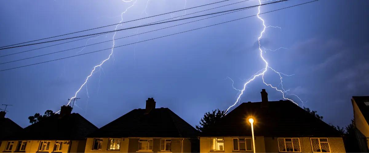 Protect your home from power surges with HVAC surge protectors. Lightning strikes above residential homes emphasize the need for reliable surge protection to prevent damage to HVAC systems.