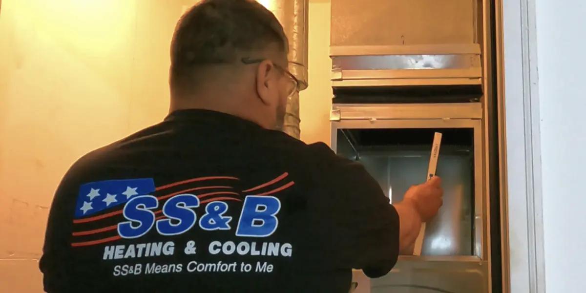 Image of our skilled service technician replacing a furnace filter in Springfield, MO.