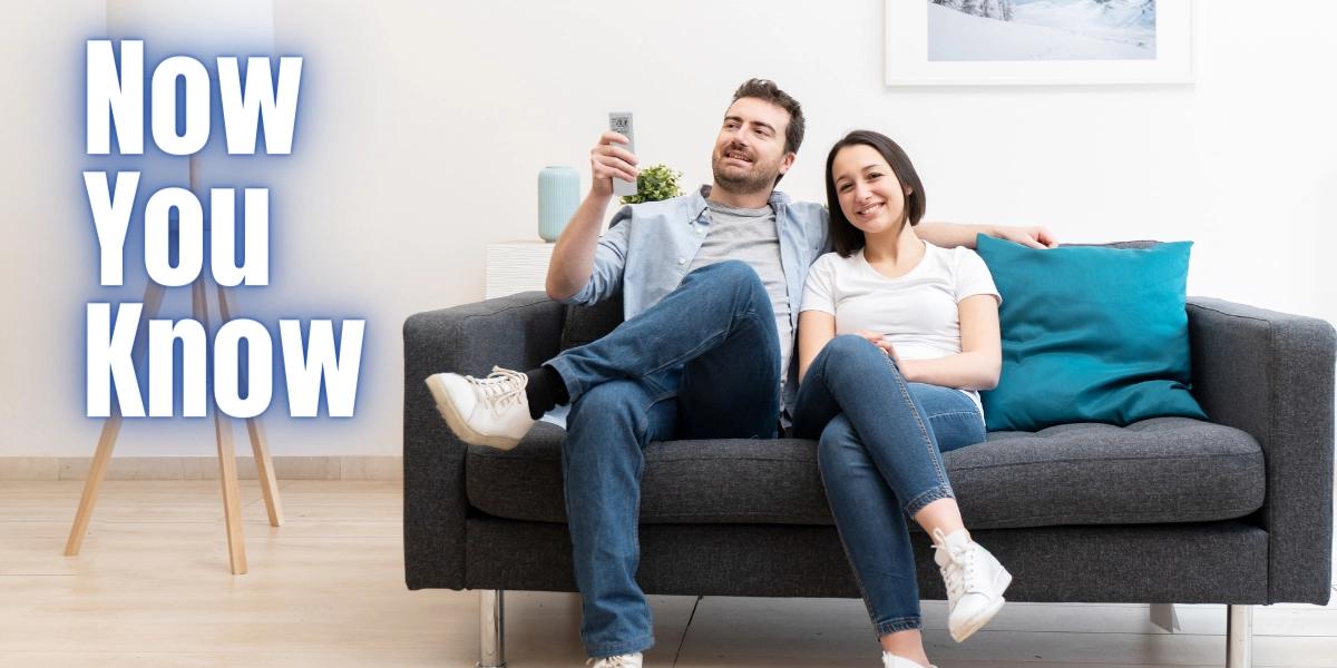 Couple sitting in living room calling SS&B Heating & Cooling.