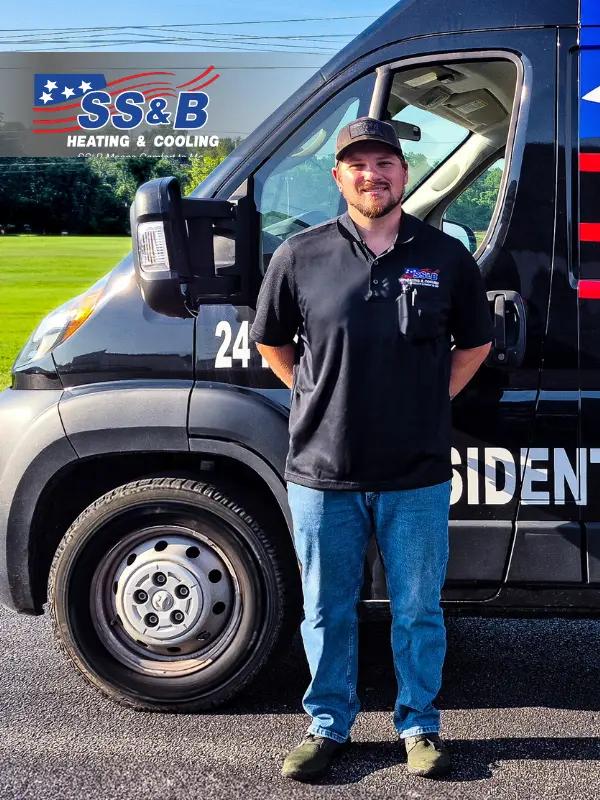 Joseph, an SS&B Heating & Cooling service technician, with years of HVAC experience in installation and repair, standing in uniform and smiling confidently.
